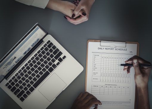 Aerial view of doctor writing patient daily report checklist
